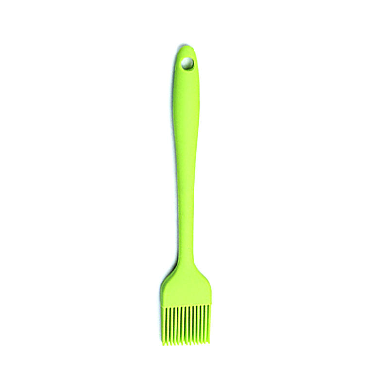Green barbecue brush on a white background