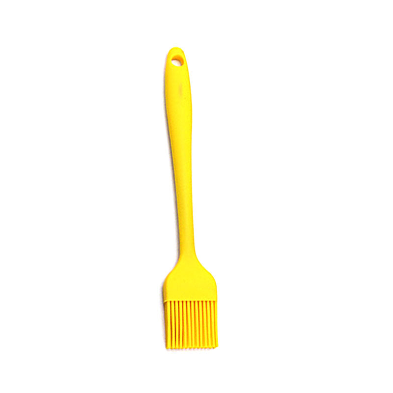 Yellow silicone brush on a white background