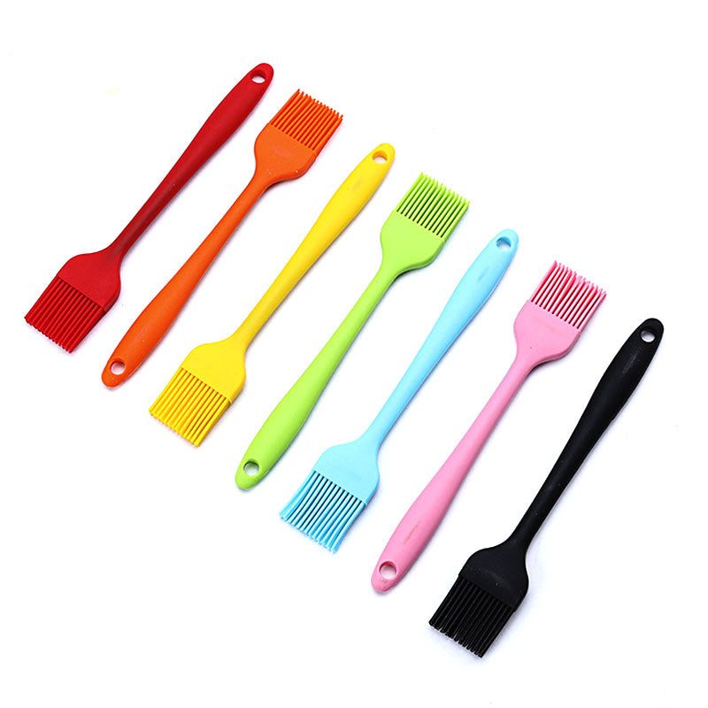 Set of colorful silicone basting brushes on a white background