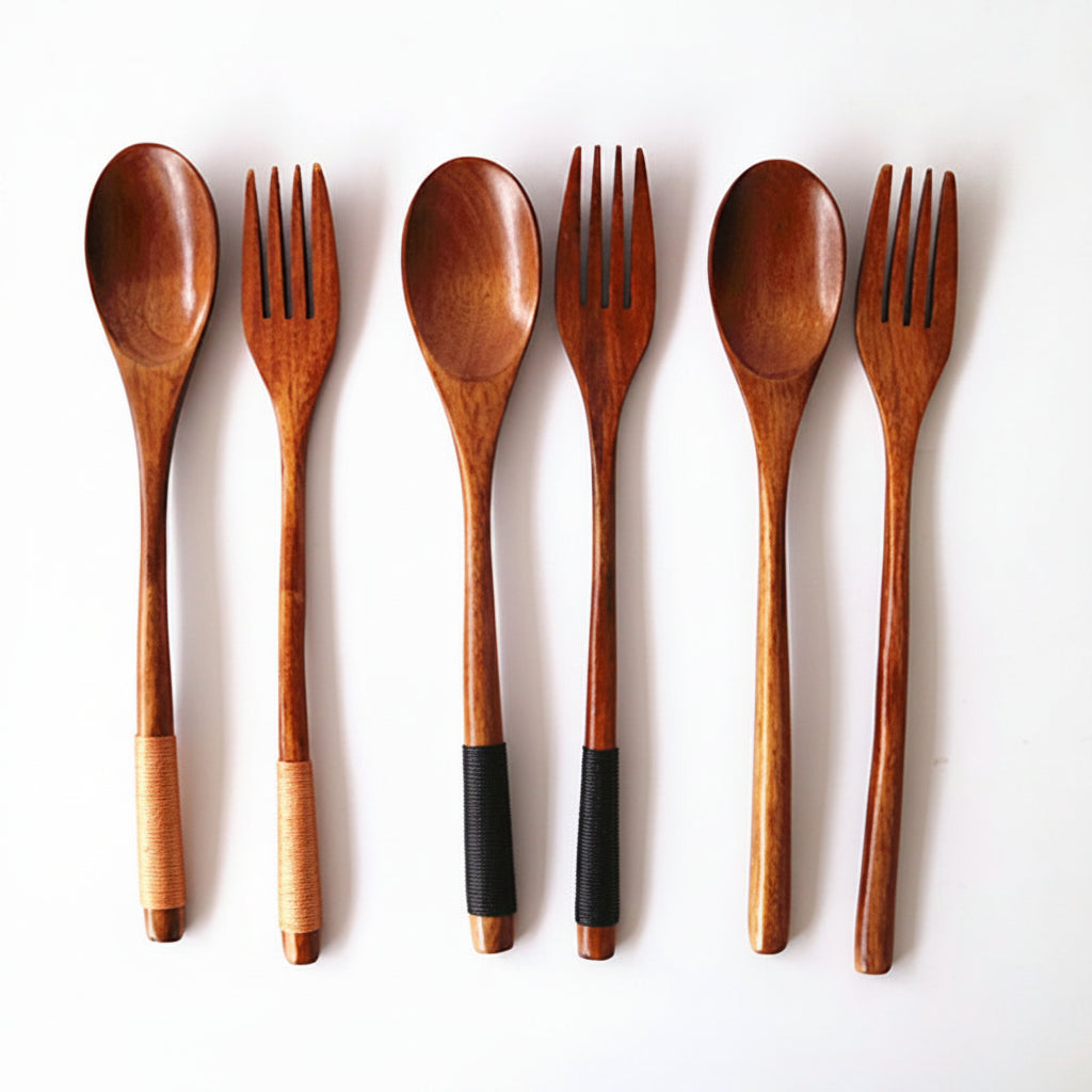 Set of wooden spoons and forks on a white background