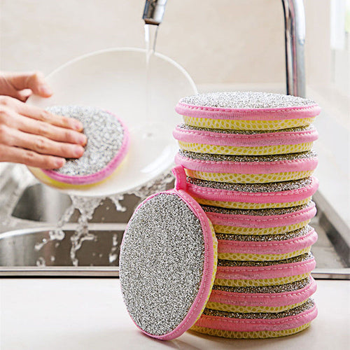 Stack of colorful scrubber pads with a hand washing a dish in the background.