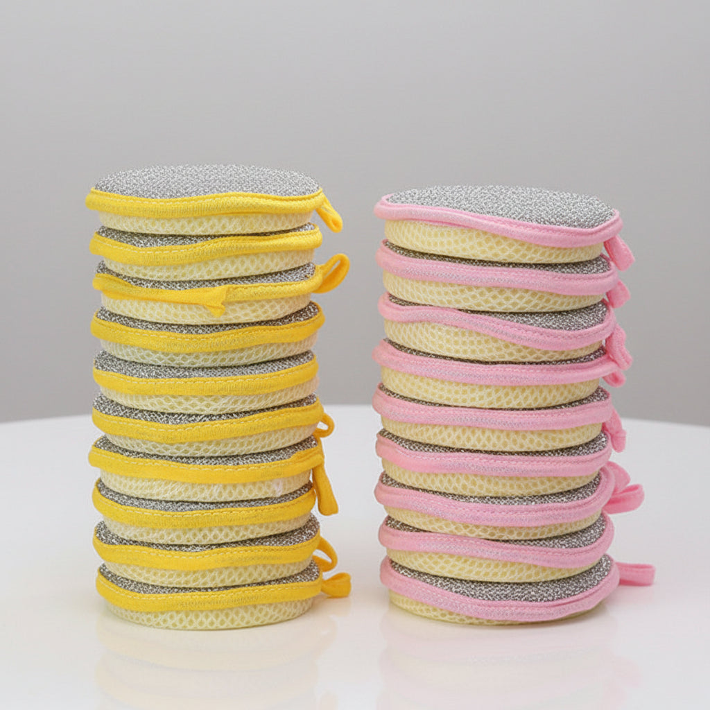Stacks of yellow and pink scrubs on a wooden surface with a blurred background