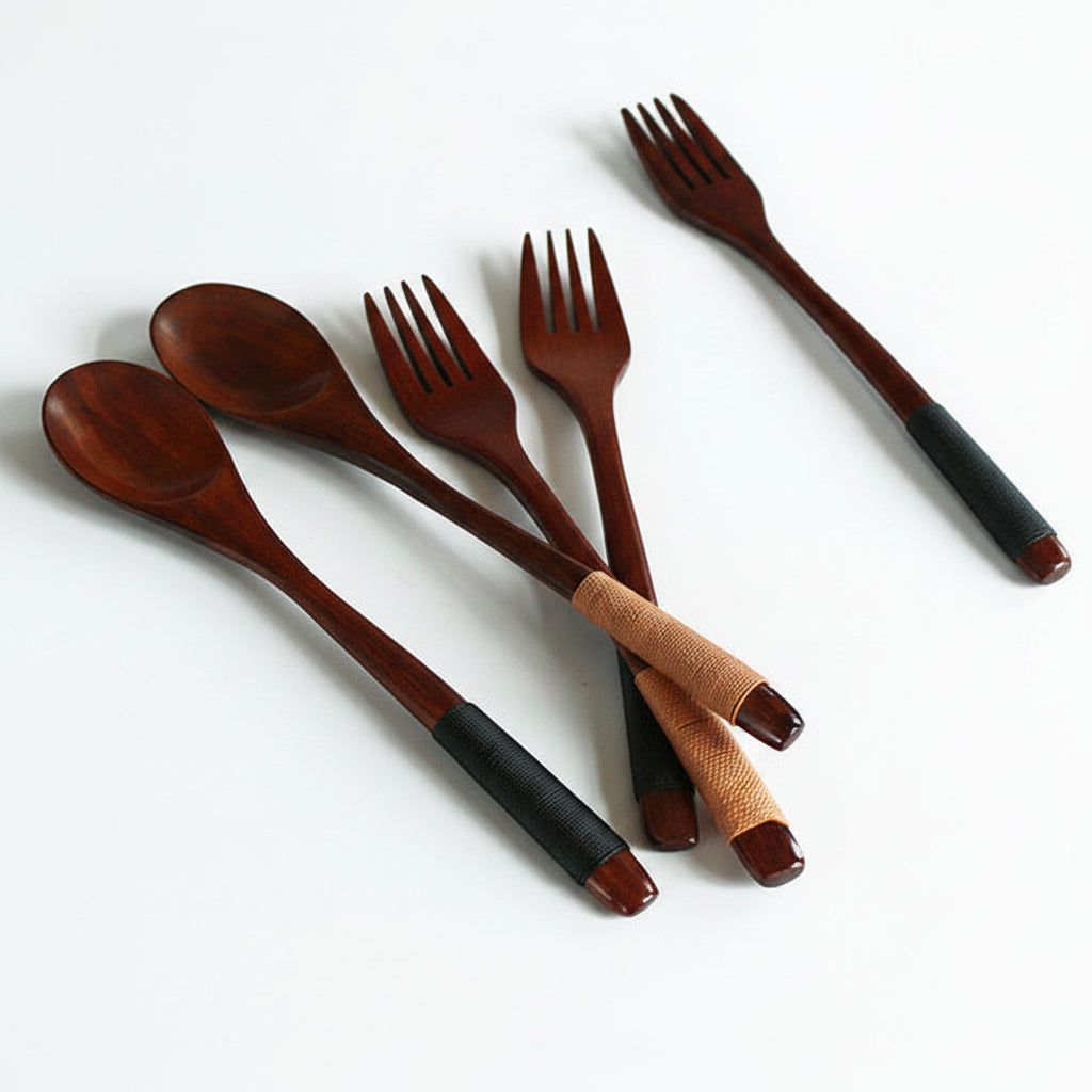 Wooden utensils with black and brown handles on a white background