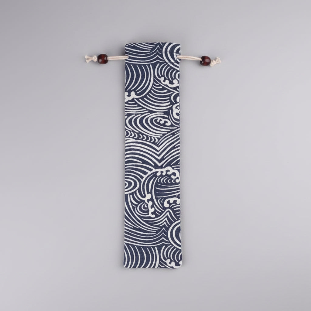 Blue and white patterned bag with drawstring on a gray concrete surface