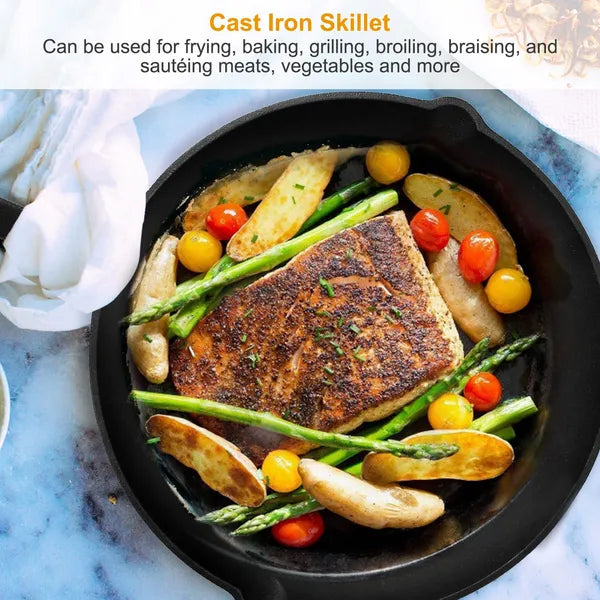 Cast iron skillet with cooked chicken, vegetables on a marble surface